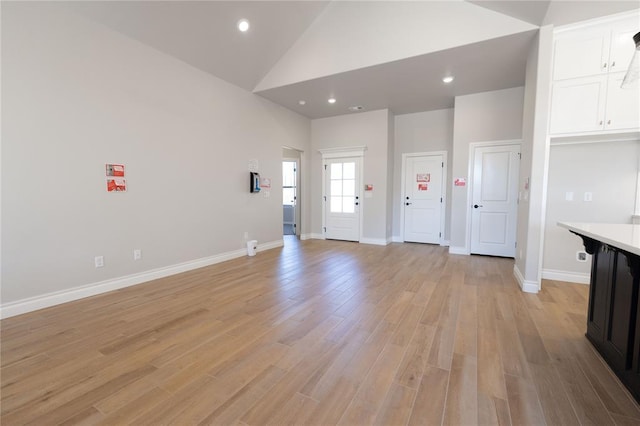 interior space featuring light hardwood / wood-style flooring and high vaulted ceiling