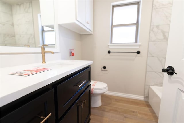 full bathroom featuring hardwood / wood-style floors, toilet, vanity, and shower / washtub combination