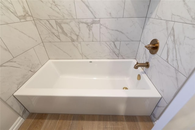 bathroom featuring hardwood / wood-style floors and a bathtub