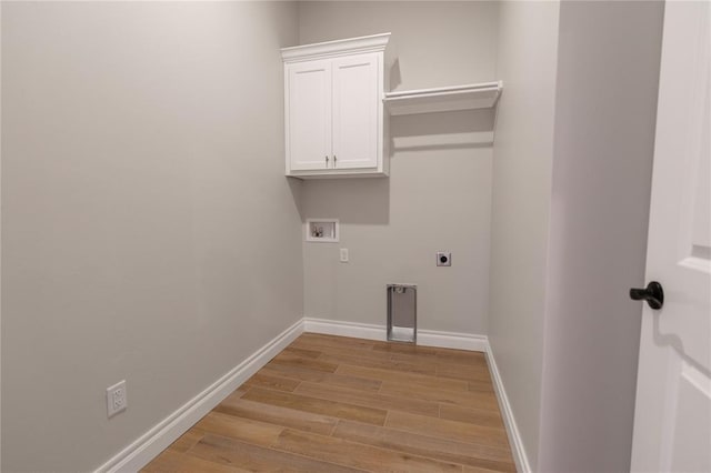 laundry area with cabinets, washer hookup, electric dryer hookup, and light wood-type flooring