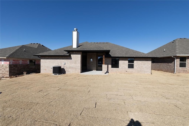 back of house with a patio area and central AC