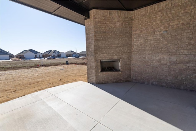 view of patio with an outdoor brick fireplace