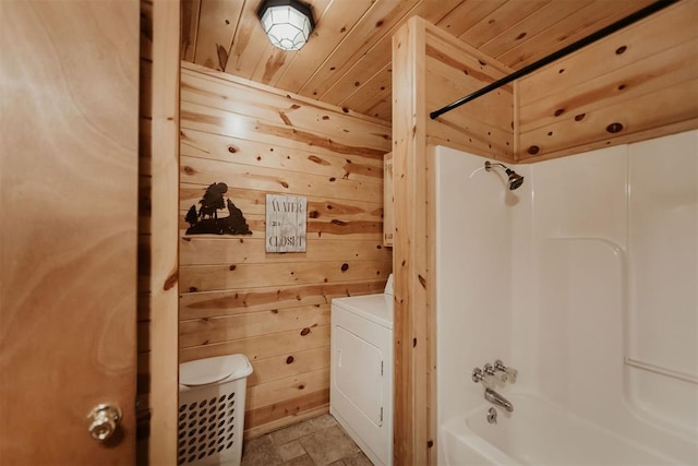 bathroom with washer / dryer, wood ceiling, tub / shower combination, and wooden walls