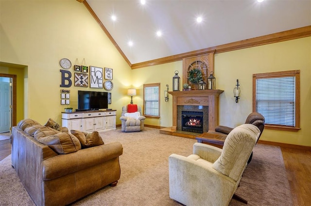 living room featuring crown molding, a fireplace, high vaulted ceiling, and light hardwood / wood-style flooring