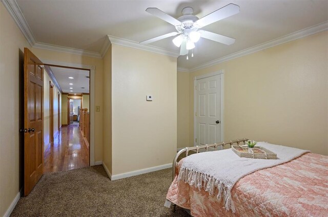 carpeted bedroom with ceiling fan and crown molding