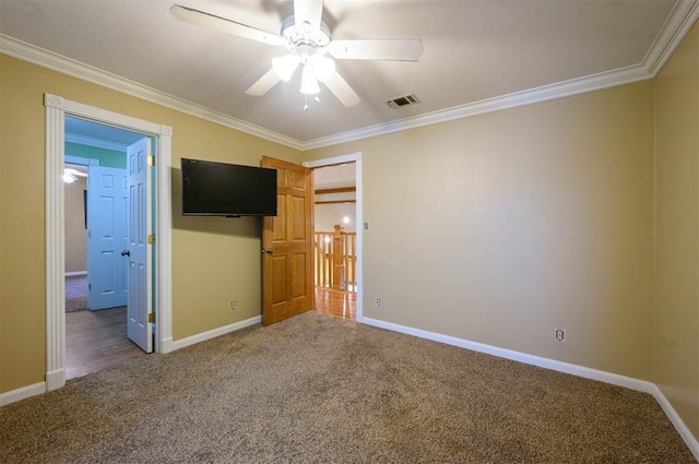 unfurnished bedroom with carpet flooring, ceiling fan, and crown molding