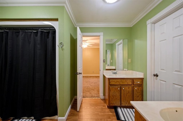 bathroom featuring vanity, ceiling fan, wood-type flooring, and crown molding