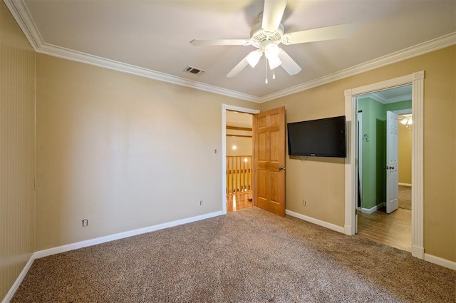 carpeted empty room featuring crown molding and ceiling fan