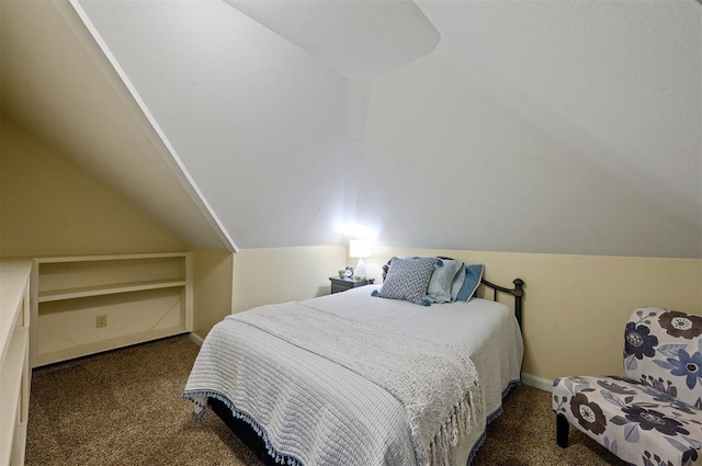 bedroom with dark carpet and lofted ceiling