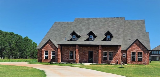 1425 W Harvard Way, Mustang, OK 73064 - view of front of home with a front yard, brick siding, and roof with shingles