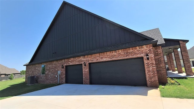 1425 W Harvard Way, Mustang, OK 73064 - view of side of property featuring board and batten siding, brick siding, and driveway