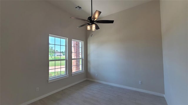 unfurnished room featuring ceiling fan, light wood-type flooring, and high vaulted ceiling