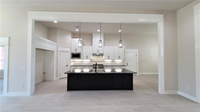 1425 W Harvard Way, Mustang, OK 73064 - kitchen with stainless steel microwave, dark countertops, backsplash, white cabinetry, and a sink