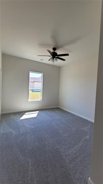 1425 W Harvard Way, Mustang, OK 73064 - carpeted spare room with ceiling fan and baseboards
