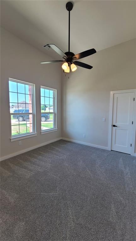 carpeted empty room featuring ceiling fan and vaulted ceiling