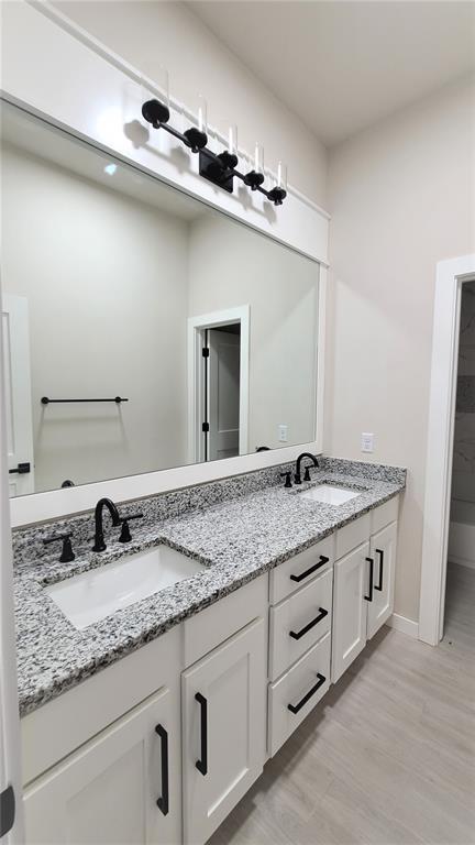 1425 W Harvard Way, Mustang, OK 73064 - full bathroom with double vanity, wood finished floors, and baseboards