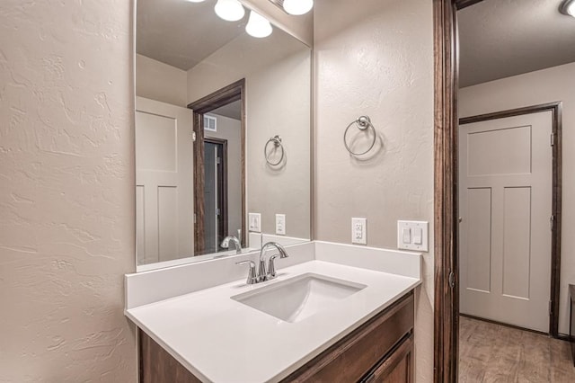 bathroom with vanity and wood-type flooring