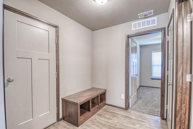 mudroom with light hardwood / wood-style flooring