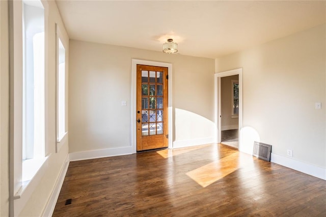 spare room featuring dark wood-type flooring