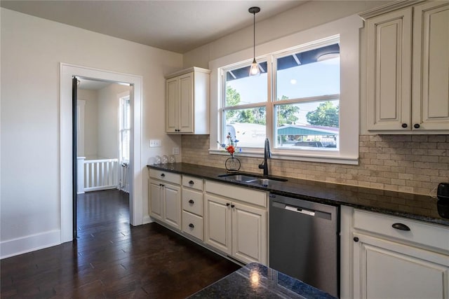 kitchen with tasteful backsplash, stainless steel dishwasher, dark wood-type flooring, sink, and pendant lighting