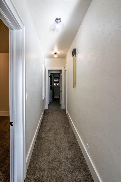 corridor with dark colored carpet