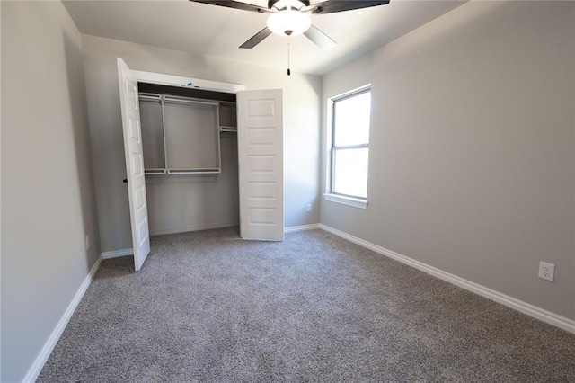 unfurnished bedroom featuring ceiling fan, a closet, and carpet flooring