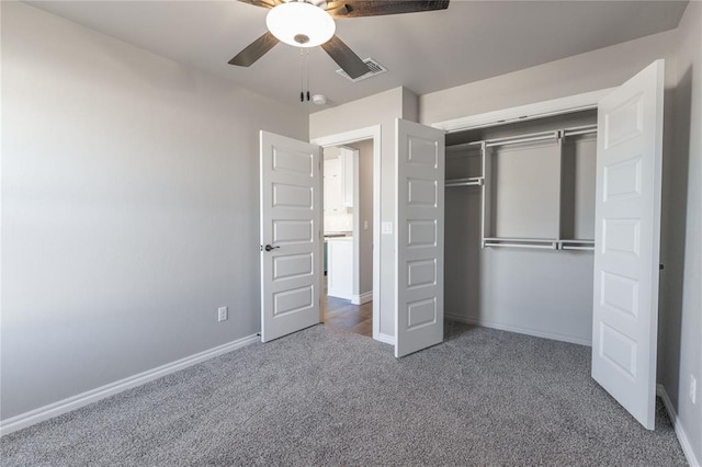 unfurnished bedroom with ceiling fan, a closet, and carpet floors