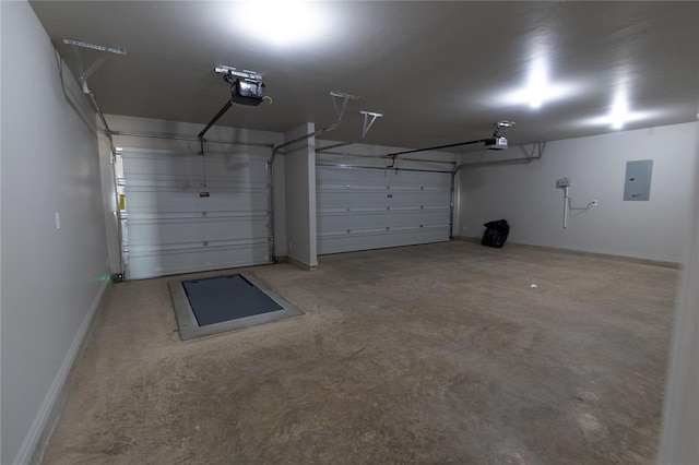 garage with a garage door opener and electric panel