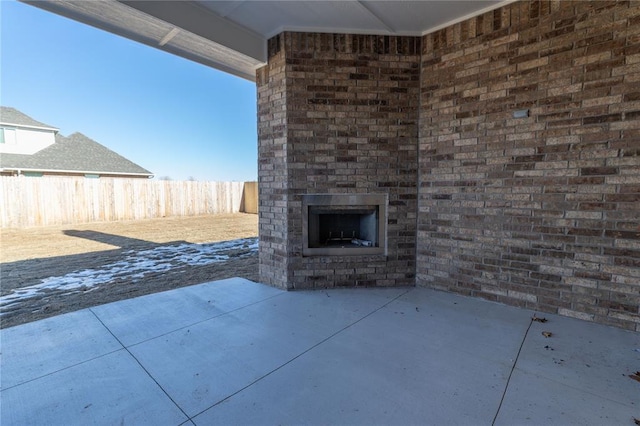 view of patio / terrace featuring an outdoor brick fireplace