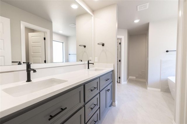 bathroom with vanity and a bathing tub