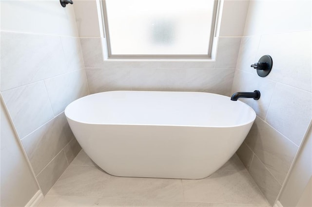 bathroom with a tub to relax in