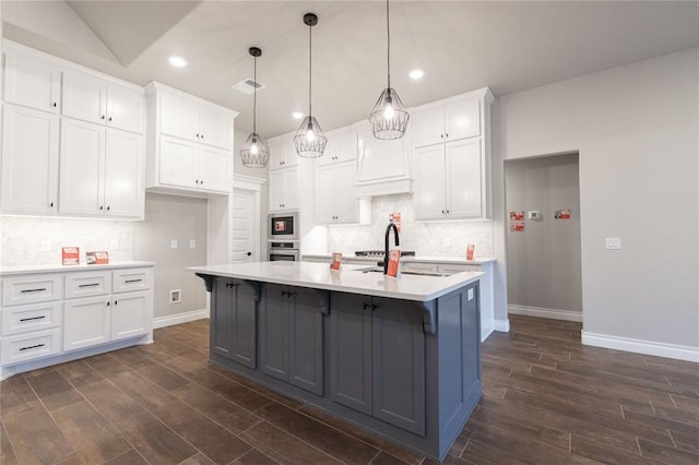 1733 Taines Turn, Norman, OK 73072 - kitchen featuring tasteful backsplash, dark wood-style floors, light countertops, and white cabinetry