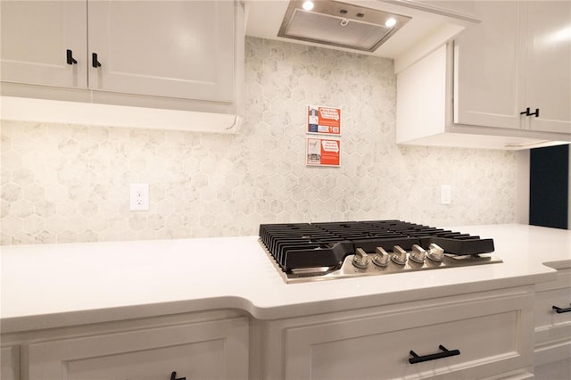 1733 Taines Turn, Norman, OK 73072 - room details featuring tasteful backsplash, white cabinets, light countertops, and stainless steel gas cooktop