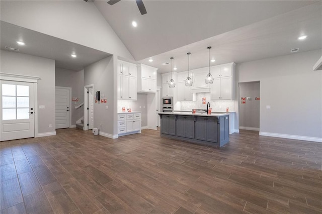 1733 Taines Turn, Norman, OK 73072 - kitchen with appliances with stainless steel finishes, white cabinets, high vaulted ceiling, a ceiling fan, and dark wood-style flooring
