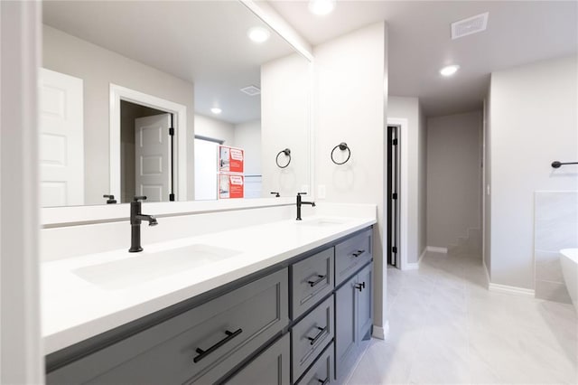 1733 Taines Turn, Norman, OK 73072 - full bathroom featuring double vanity, visible vents, a washtub, and a sink