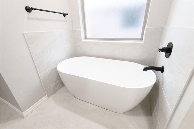 1733 Taines Turn, Norman, OK 73072 - bathroom with tile patterned flooring, a soaking tub, and tile walls
