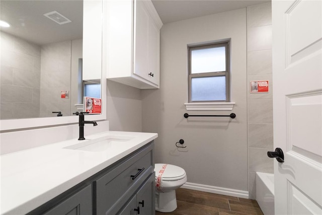 1733 Taines Turn, Norman, OK 73072 - bathroom with visible vents, toilet, wood finished floors, baseboards, and vanity