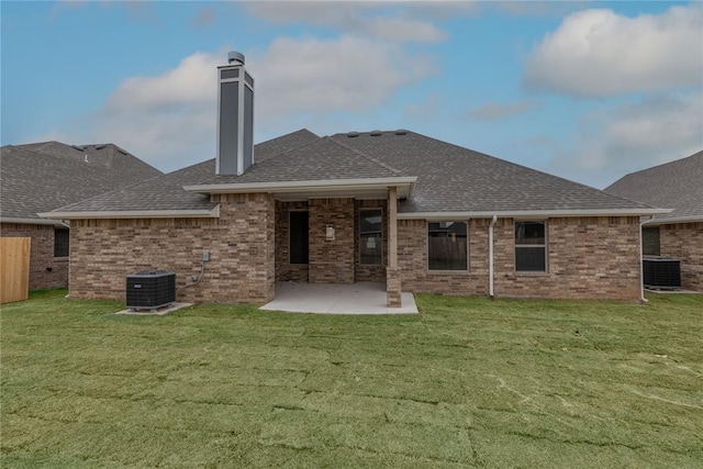 1733 Taines Turn, Norman, OK 73072 - back of house with a lawn, roof with shingles, brick siding, and a patio area