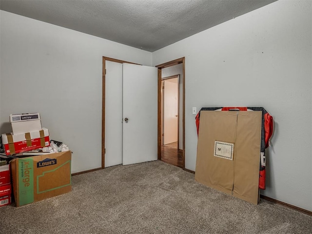 interior space featuring a closet, carpet, and a textured ceiling