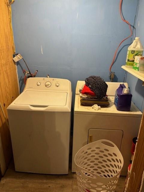 washroom with hardwood / wood-style floors and washer and dryer