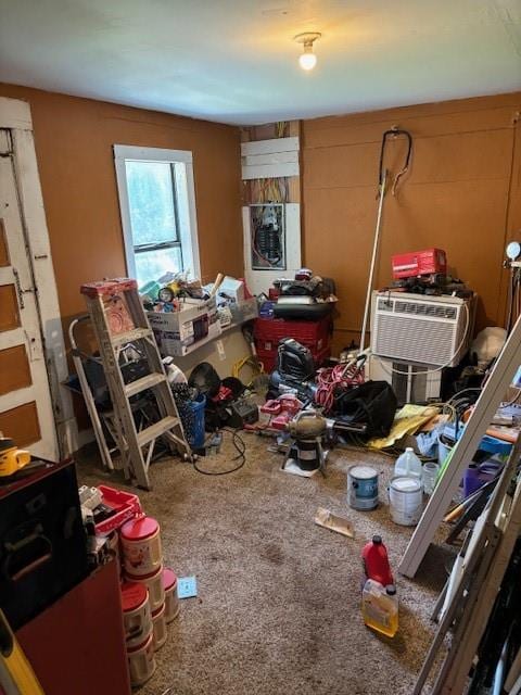 misc room with a wall mounted air conditioner and carpet floors