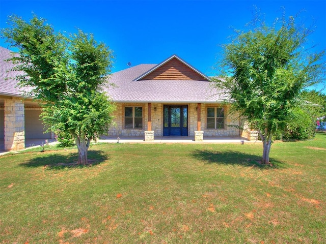 exterior space with a porch, a garage, and a front lawn