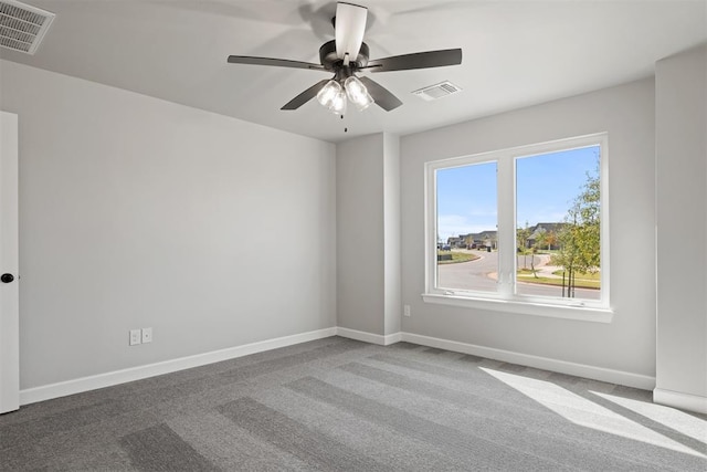 carpeted spare room with ceiling fan