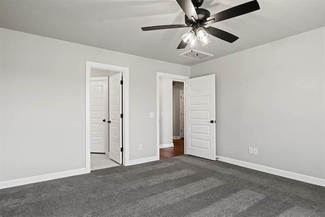 unfurnished bedroom featuring dark colored carpet and ceiling fan