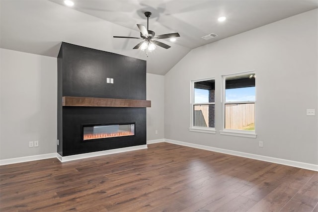 unfurnished living room with ceiling fan, a large fireplace, lofted ceiling, and dark wood-type flooring