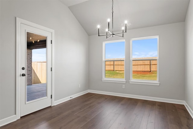 unfurnished dining area featuring vaulted ceiling, dark hardwood / wood-style floors, and an inviting chandelier