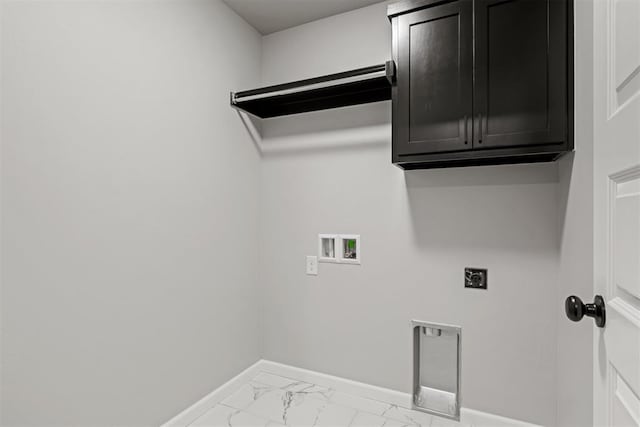 clothes washing area featuring hookup for an electric dryer, hookup for a washing machine, and cabinets