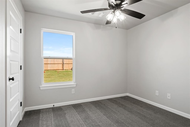 unfurnished room with dark carpet and ceiling fan