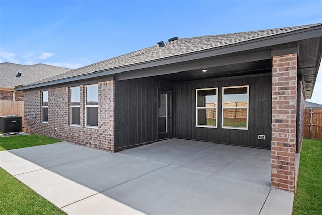 back of property featuring central air condition unit and a patio area