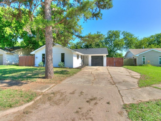 ranch-style home with a garage and a front yard